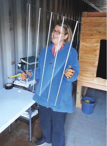 Christine Sheppard at the American Bird Conservancy tests patterned glass that helps prevent window collisions.