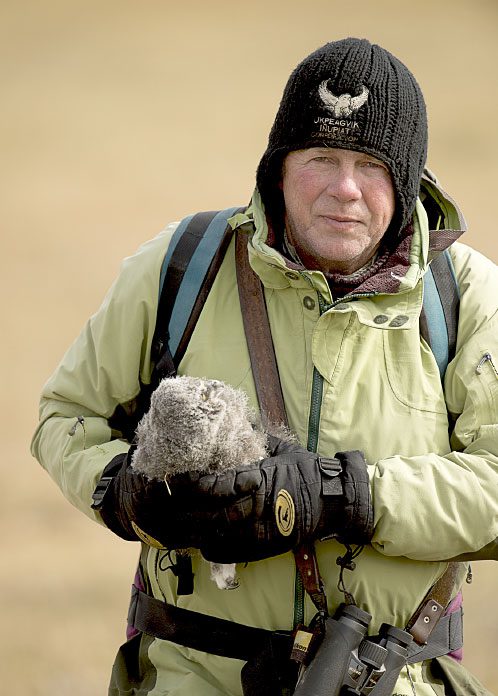 Denver Holt with a young Snowy Owl. Photo by Dan Cox.