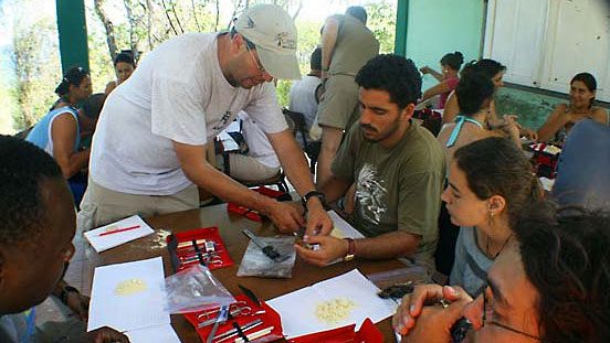 Eduardo Iñigo-Elias and Cornell University professor David Winkler (background, standing) teach bird anatomy at the Siboney Ecological Institute in Santiago de Cuba, in 2009.