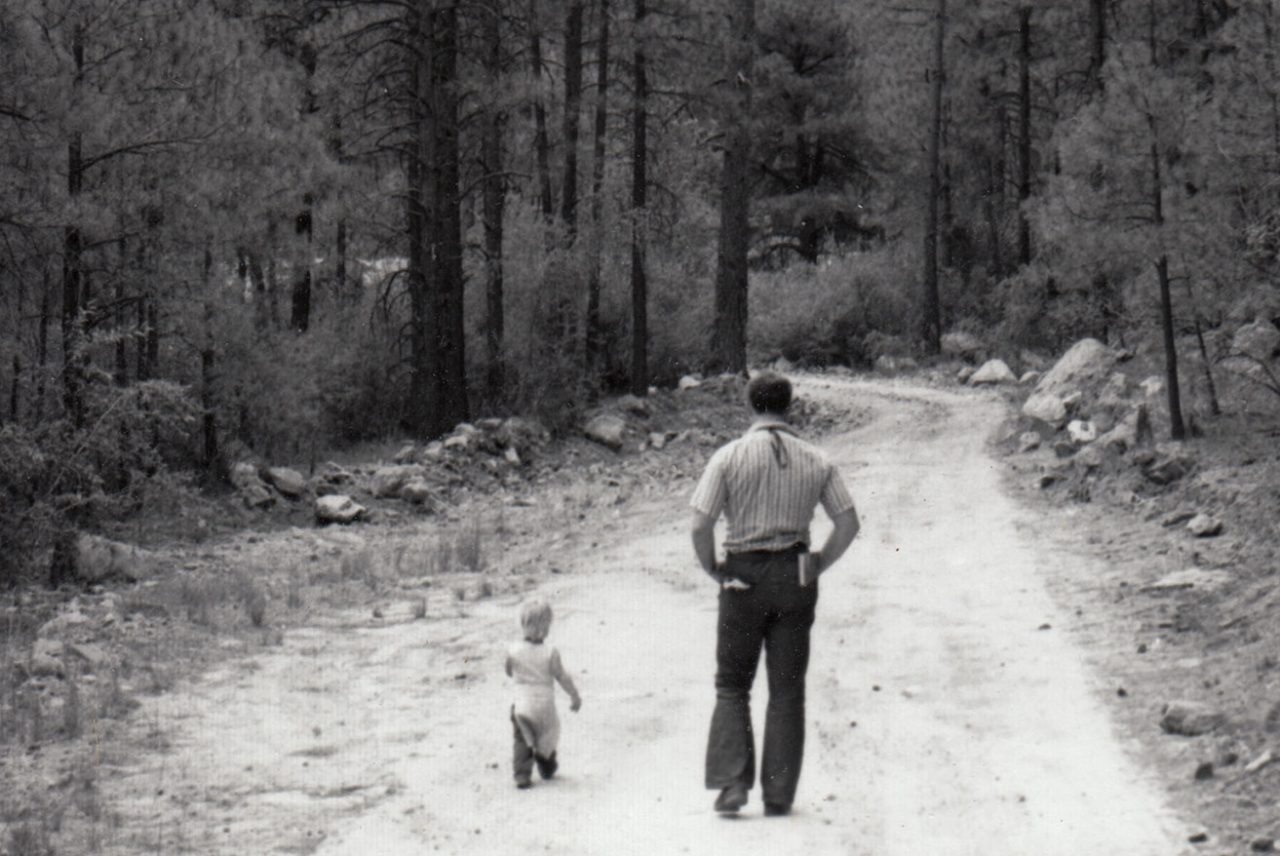 walking down a road - black and white photo