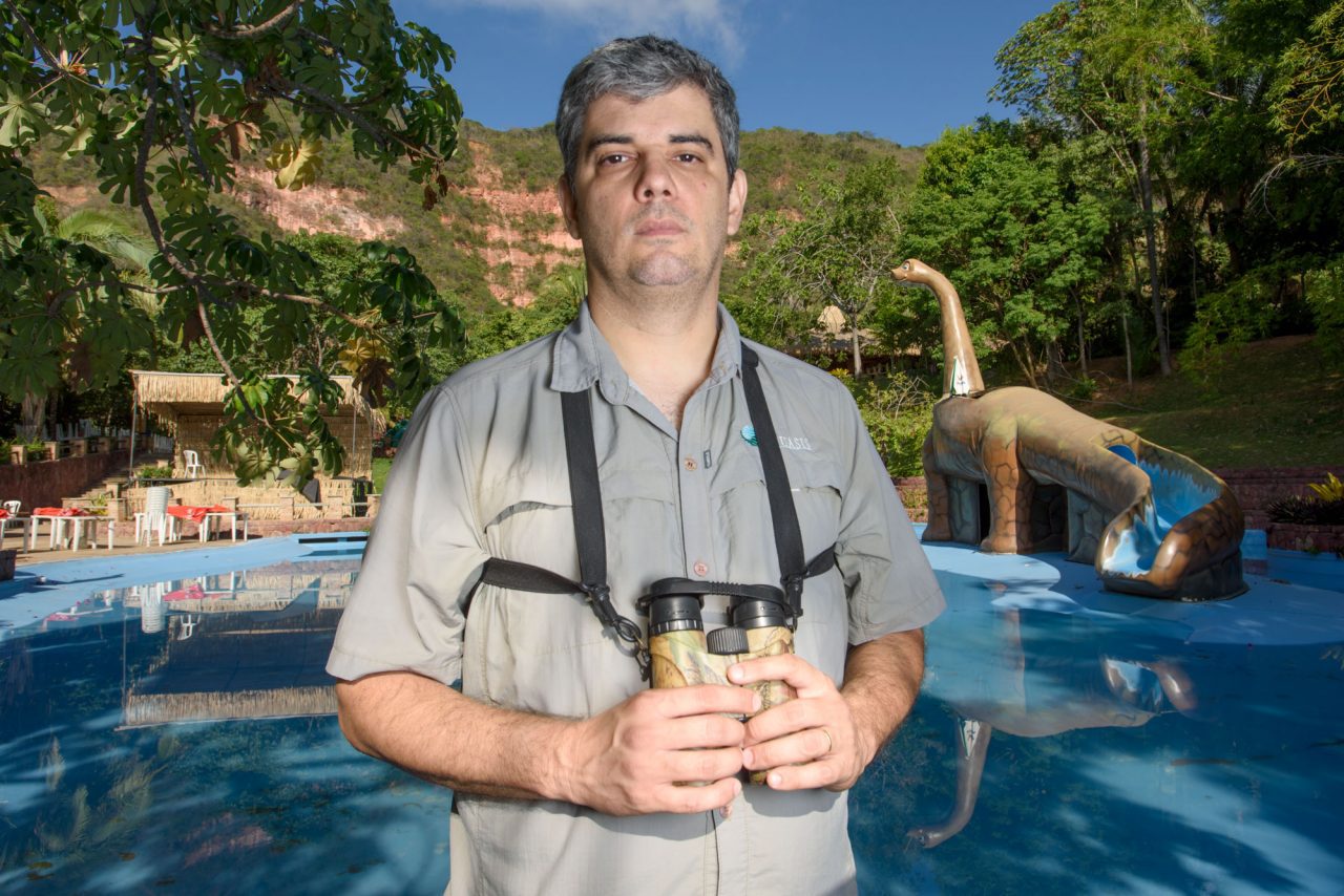 Ornithologist Weber de Girao Silva stands near the place where he discovered the Araripe Manakin in 1996. Twenty years ago this region was forested, but today the area of Silva’s discovery is a water park. In a small private forest reserve in a corner of the park, some manakins still persist. Photo by Gerrit Vyn