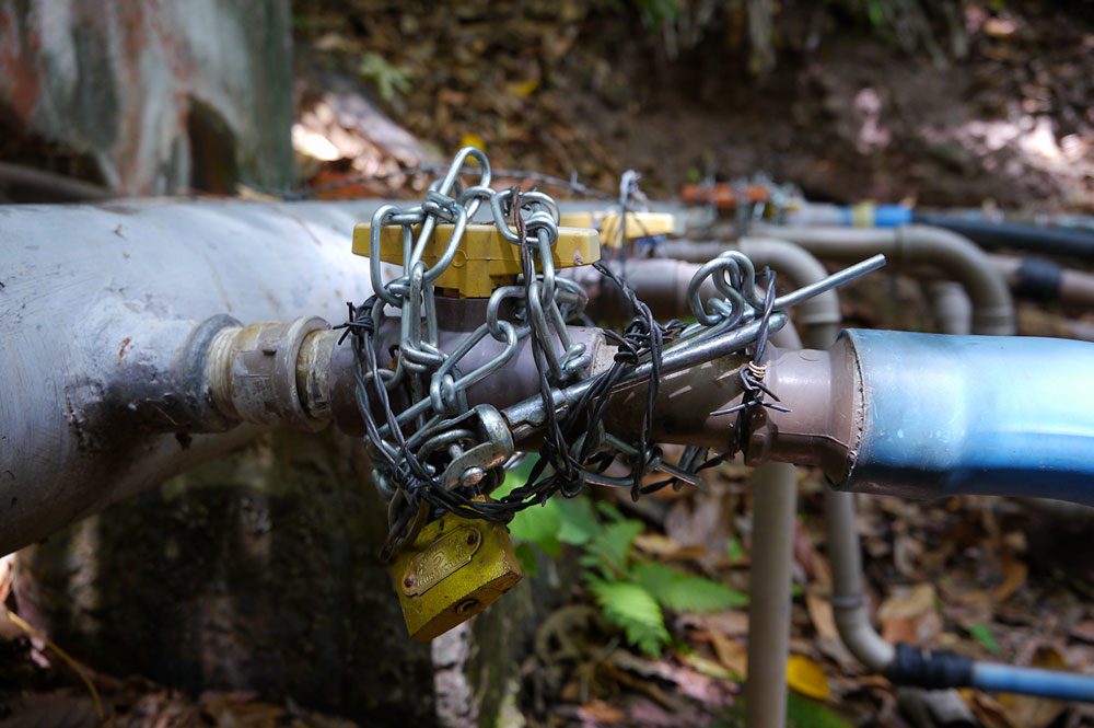 The area has a history of water conflicts. Some pipe taps are wrapped in barbed wire so no one can them off. Photo by Gerrit Vyn.