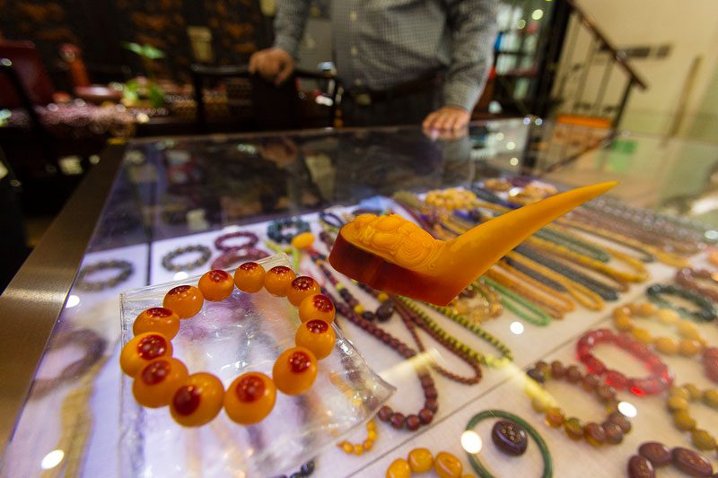 Illegal hornbill casque bracelet and artwork for sale in a shop in Shanghai, China, in 2017. Photo by Tim Laman.