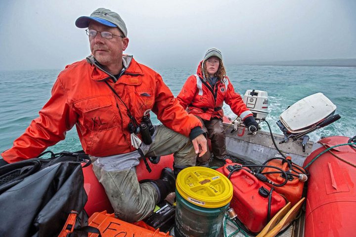 Author Irby Lovette and USGS biologist Stephanie Walden ferry gear from the Alaska Maritime National Wildlife Refuge’s research vessel R/V Tiglax to their remote research encampment on St. Matthew Island, 200 miles off the coast of mainland Alaska. Photo by Andy Johnson.