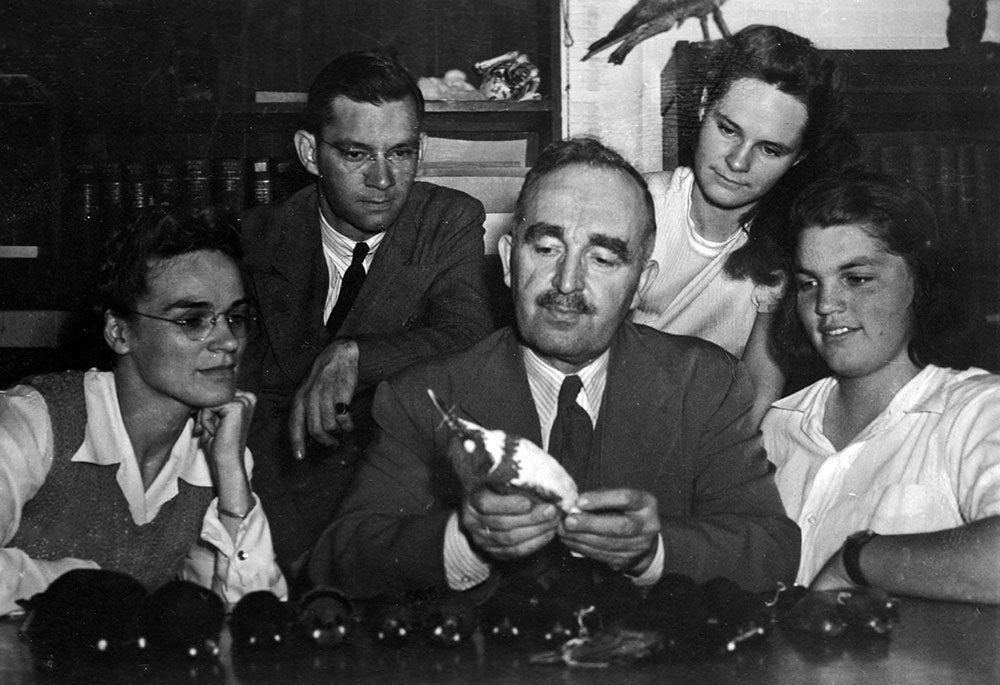 Arthur Allen examines a Belted Kingfisher as Cornell graduate student Brina Kessel (far right) looks on. In 1961, Allen gave Kessel a copy of his Book of Bird Life with the inscription “to the best student we ever had.”