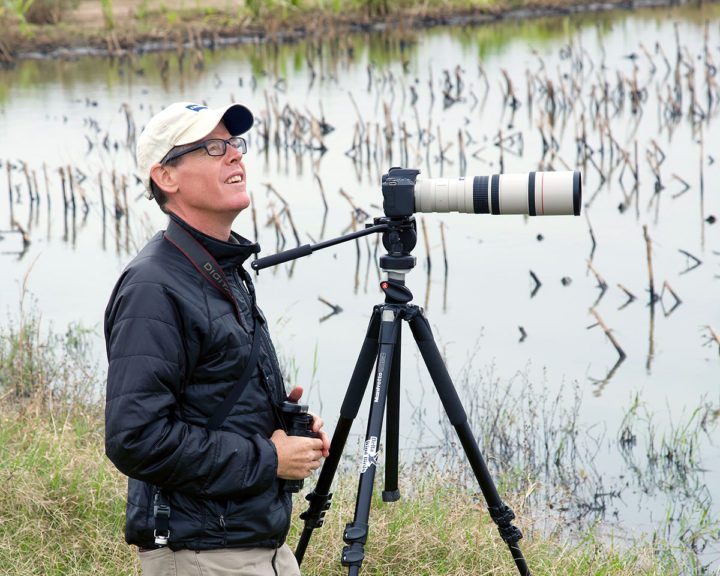 Ecologist Jason Hoeksema monitors the flooded the fields on James Failing’s farm. Migratory shorebirds flocked to this temporary wetland habitat. Photo by Larry Pace.