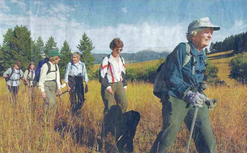 Mary Geis leads a group of women hikers through a field near Bozeman Montana