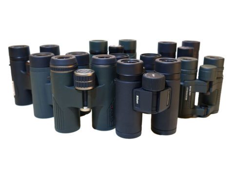 a group of small binoculars arranged against a white background