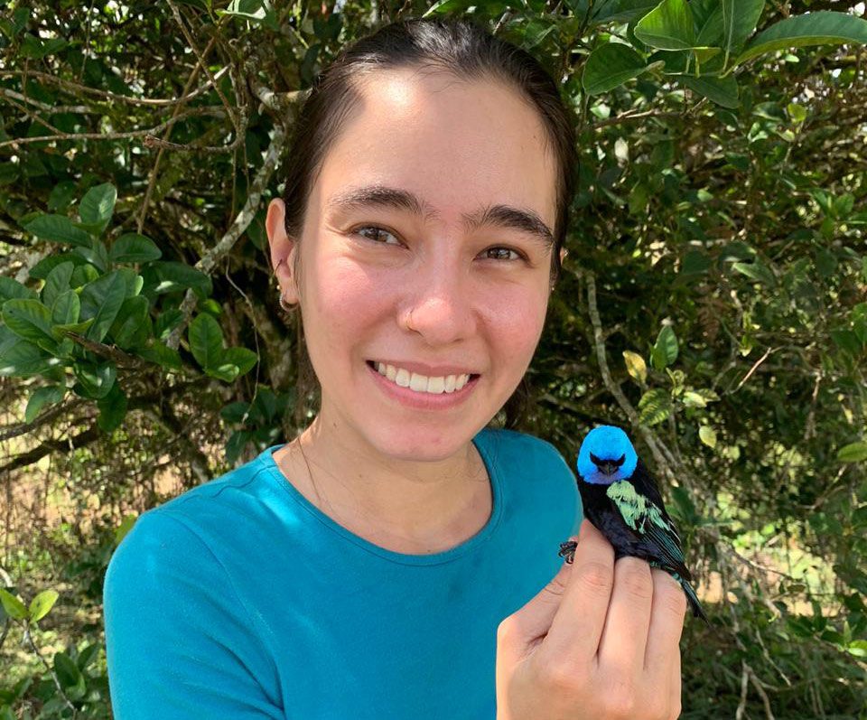 woman with blue-headed bird