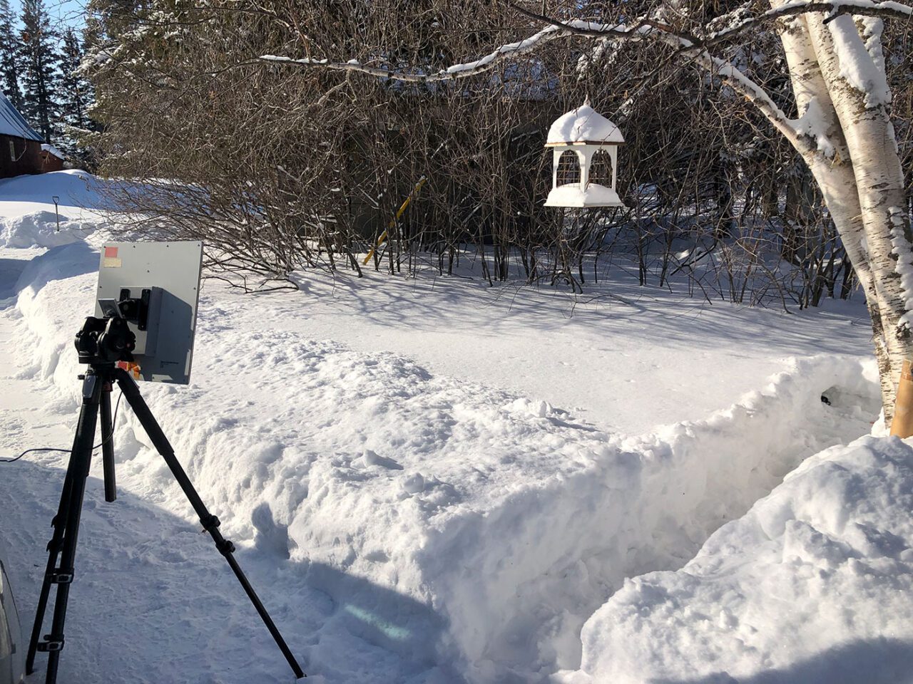 Strange looking camera ponied towards the snowy ground.