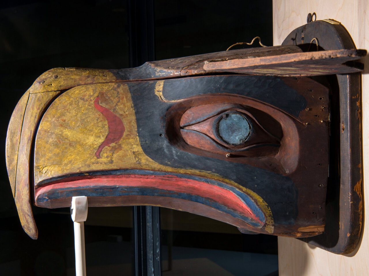 carved wooden mask of an eagle head